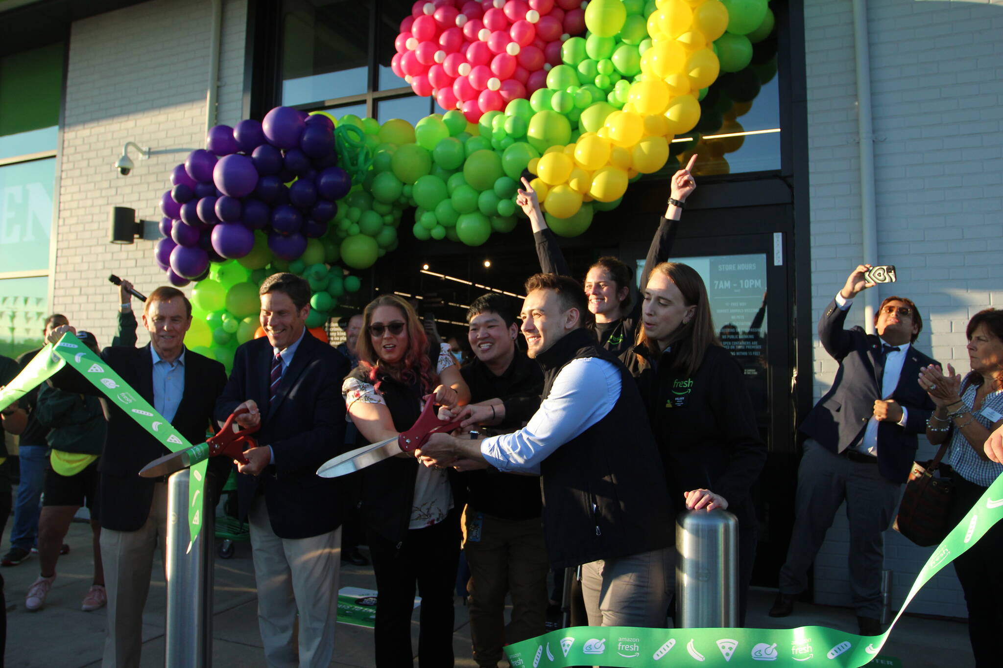 City officials and Amazon Fresh staff help cut the ribbon on opening day of the Amazon Fresh store.