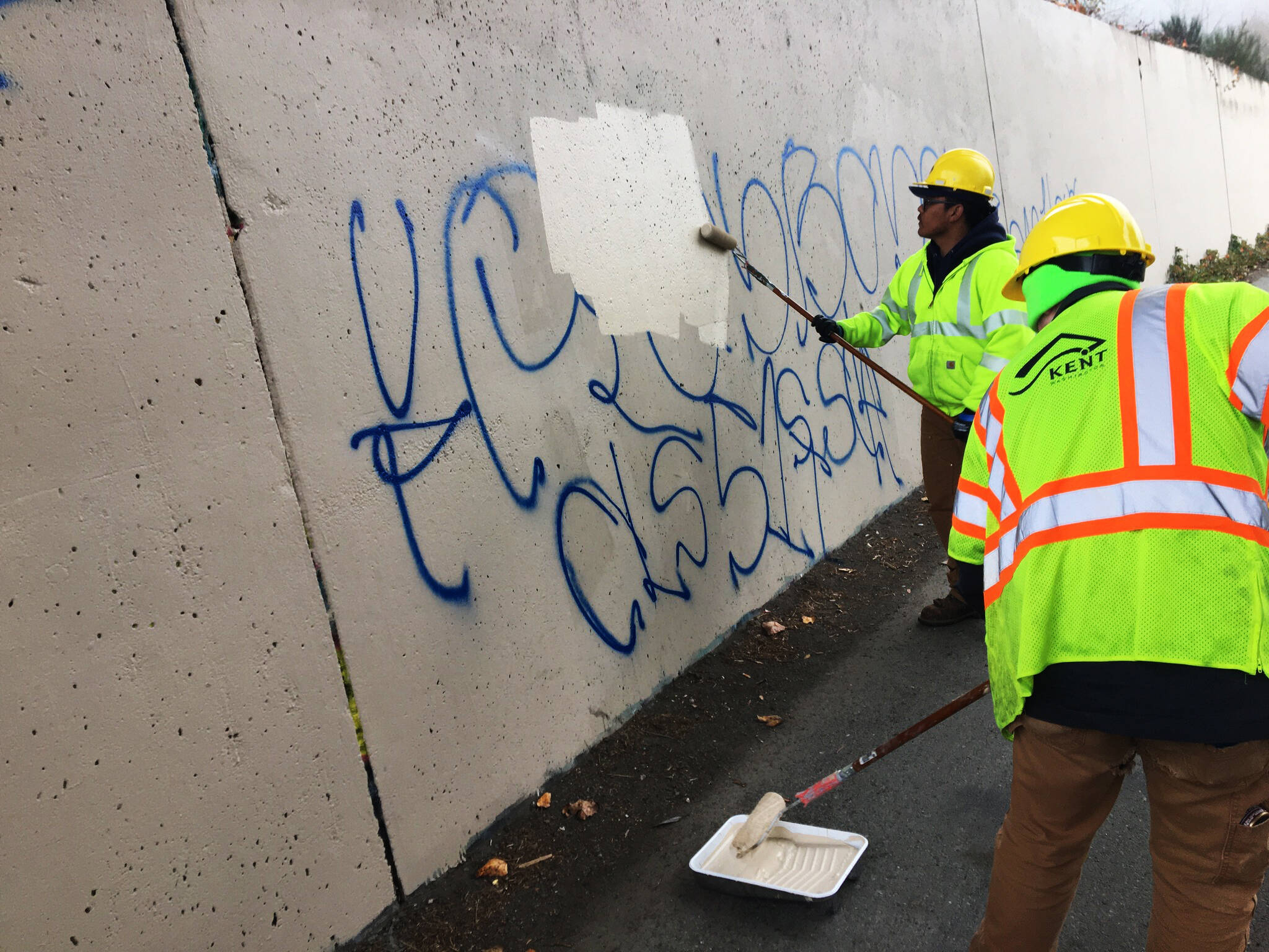 Kent city crews paint over graffiti earlier this year. COURTESY PHOTO, City of Kent