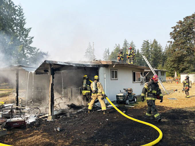 Firefighters extinguish a house fire the morning of Sept. 9 in the 27200 block of 156th Avenue SE in Kent. COURTESY PHOTO, Puget Sound Fire
