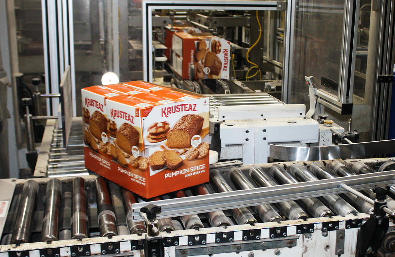 Boxes of Krusteaz Pumpkin Spice bread mix head down the production line at the Kent facility. STEVE HUNTER, Kent Reporter