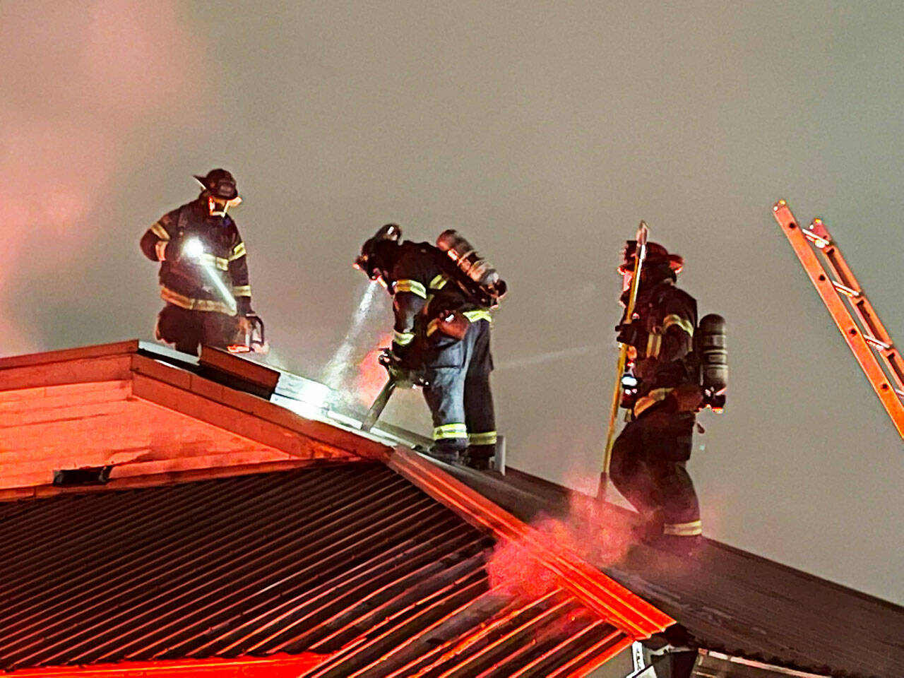 Firefighters on the roof of a fire early Wednesday, Oct. 5 at All Seasons Dental Care, 120 State Ave. N. COURTESY PHOTO, Puget Sound Fire