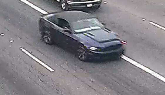 The suspect the shooting of a 9-year-old boy is still at large, last seen driving this dark blue Ford Mustang convertible with white writing on the lower portion of the windshield. Photo courtesy of Washington State Patrol.