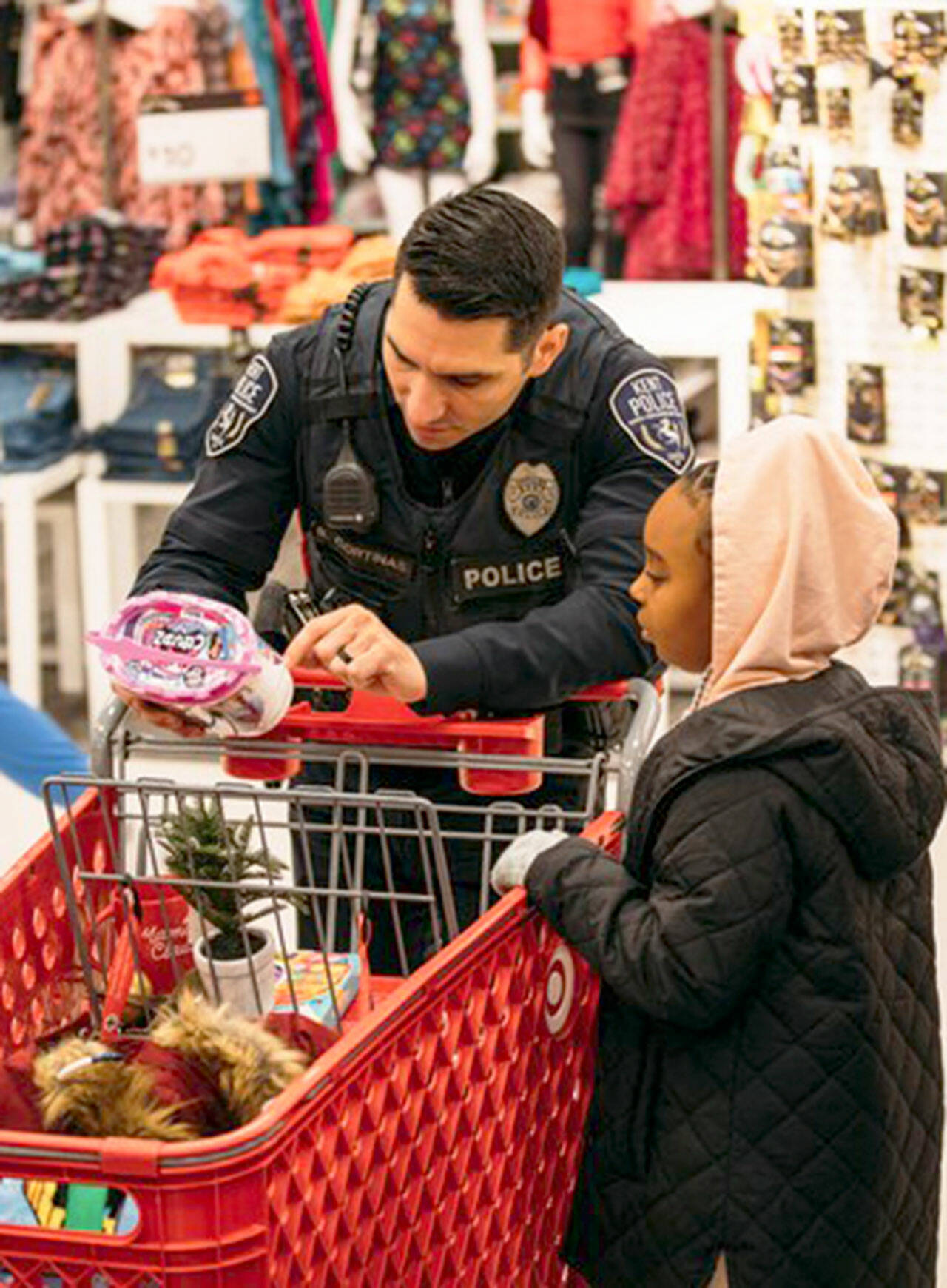 Kent Police Officer Cortinas helps pick out gifts during Shop with a Cop on Dec. 10 at Target. COURTESY PHOTO, Kent Police