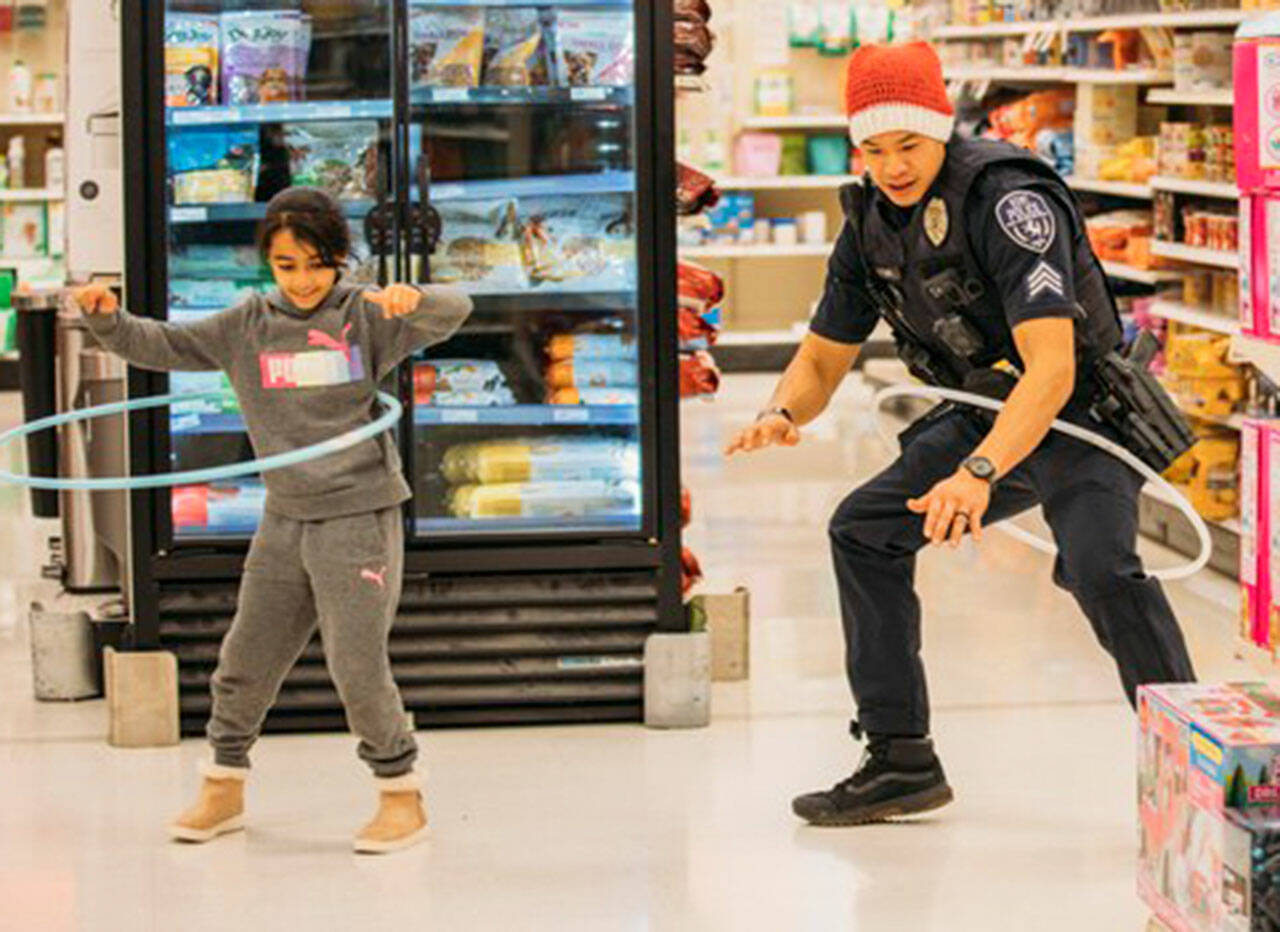Kent Police Sgt. Tung and a girl take a fun break during Shop with a Cop. COURTESY PHOTO, Kent Police