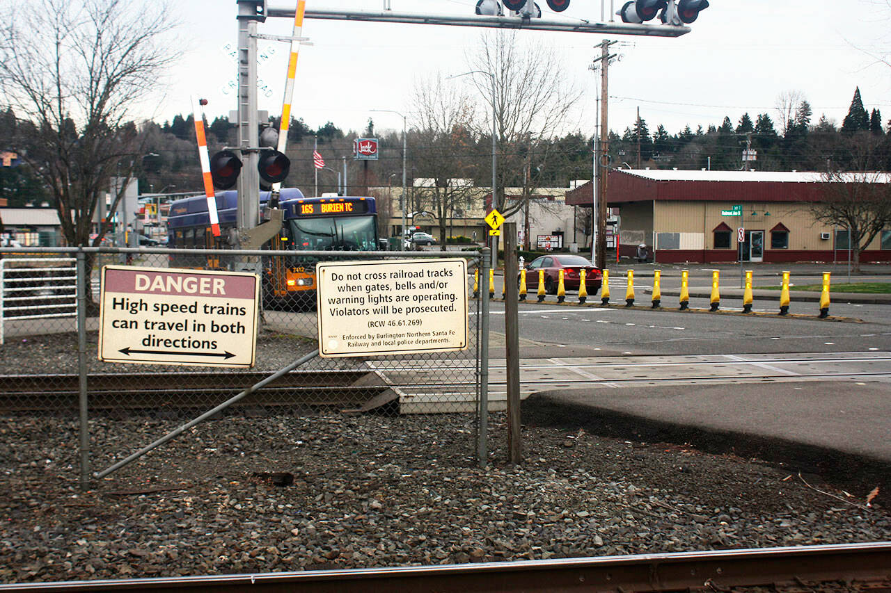 Signs warn pedestrians about crossing the tracks in Kent. STEVE HUNTER, Kent Reporter