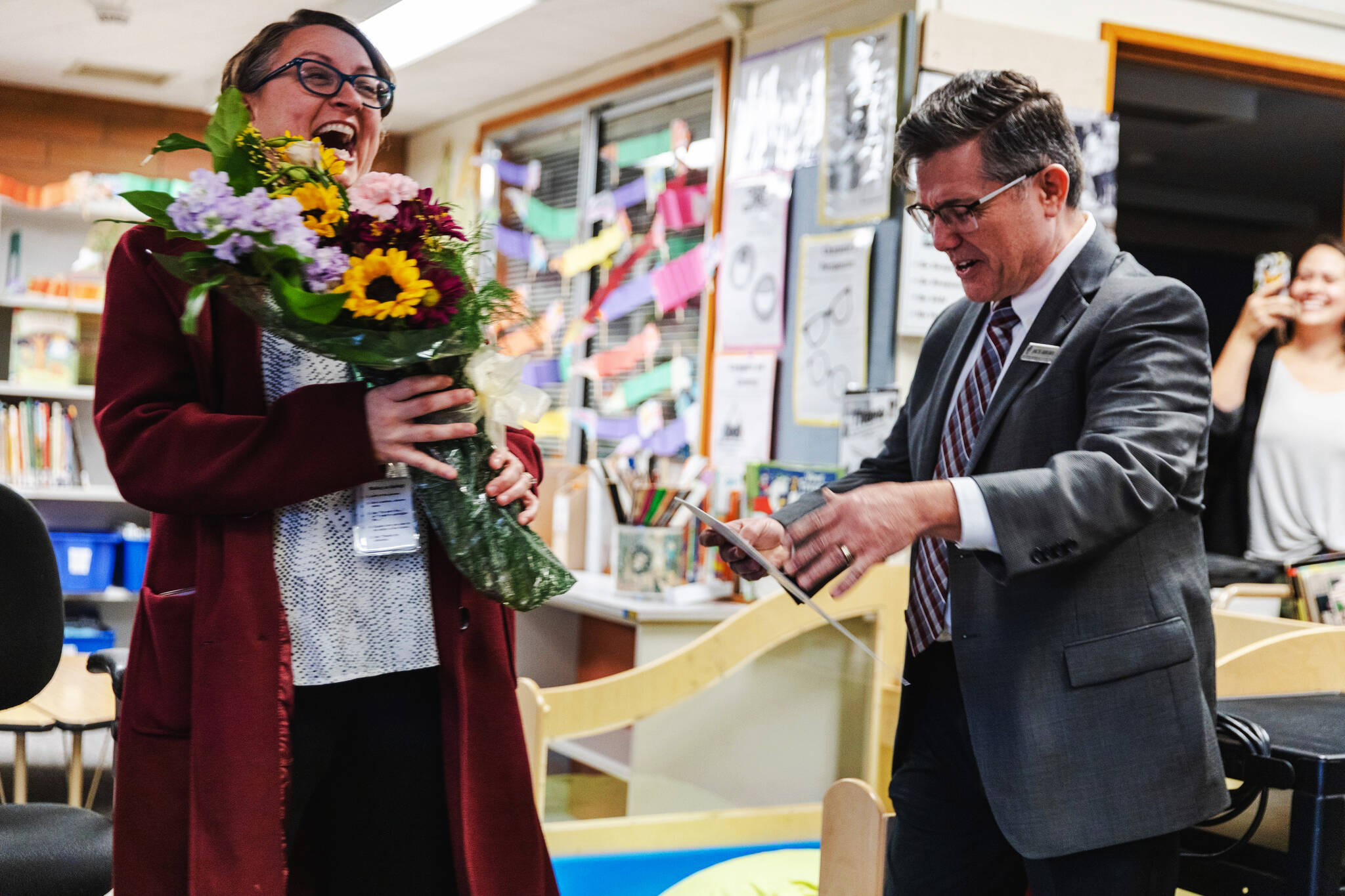 Pine Tree Elementary School Principal Dana Stiner accepts congratulations for state Principal of the Year honors from Jack Arend, deputy director at Association of Washington School Principals. COURTESY PHOTO, Kent School District