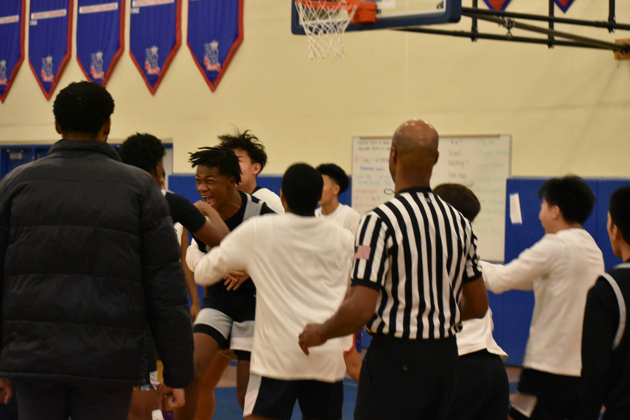 Sophomore Jaevieon Jamerson being celebrated as he made the go-ahead basket. Photo Credit: Ben Ray/ The Reporter