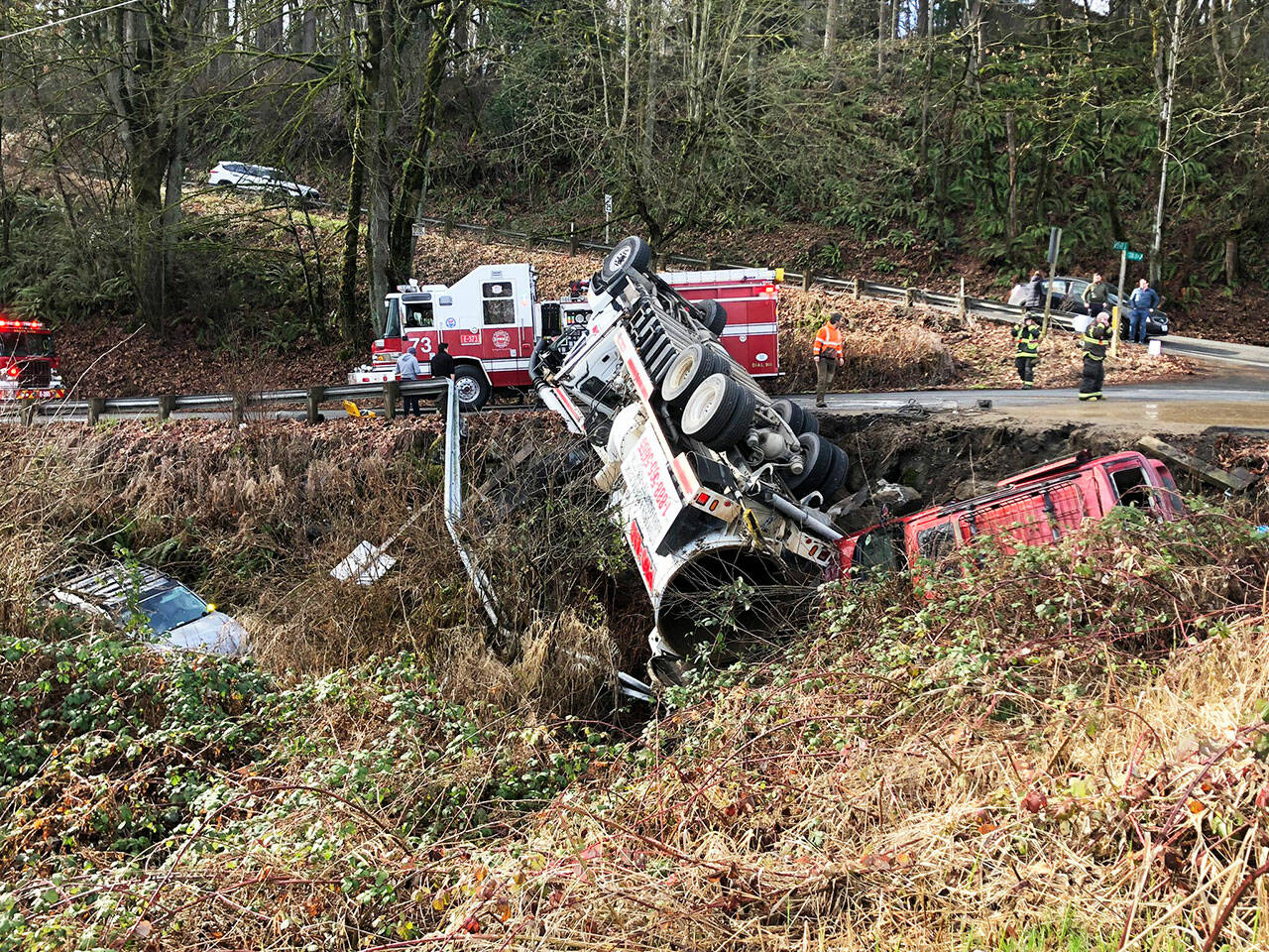 Three vehicles went over an embankment Wednesday morning, Feb. 8 near 55th Avenue South and South 272nd Street in unincorporated King County. One person suffered a minor injury. Four people escaped injury. COURTESY PHOTO, Puget Sound Fire