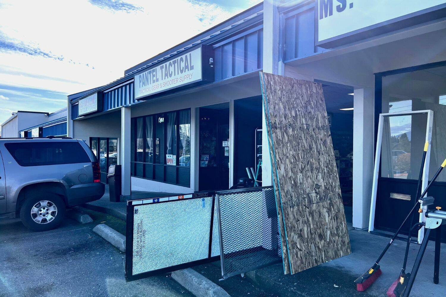 The glass doors smashed by burglars with a truck early in the morning of Feb. 15 are removed as employees clean up the scene. Cameron Sheppard / the Reporter
