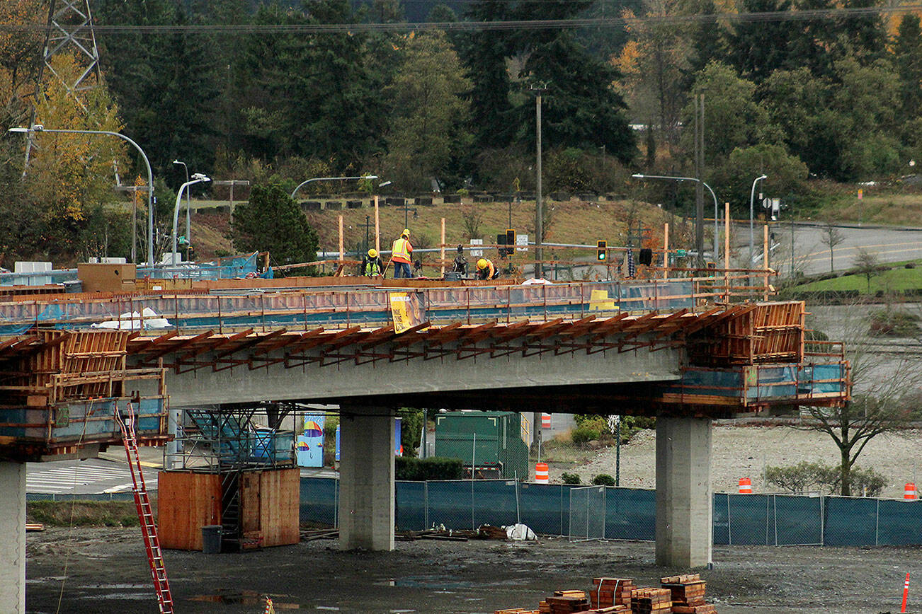 Construction workers work on the final stop of the Federal Way Link Extension light rail route along South 320th Street in Federal Way on Nov. 19, 2021. Olivia Sullivan, Sound Publishing