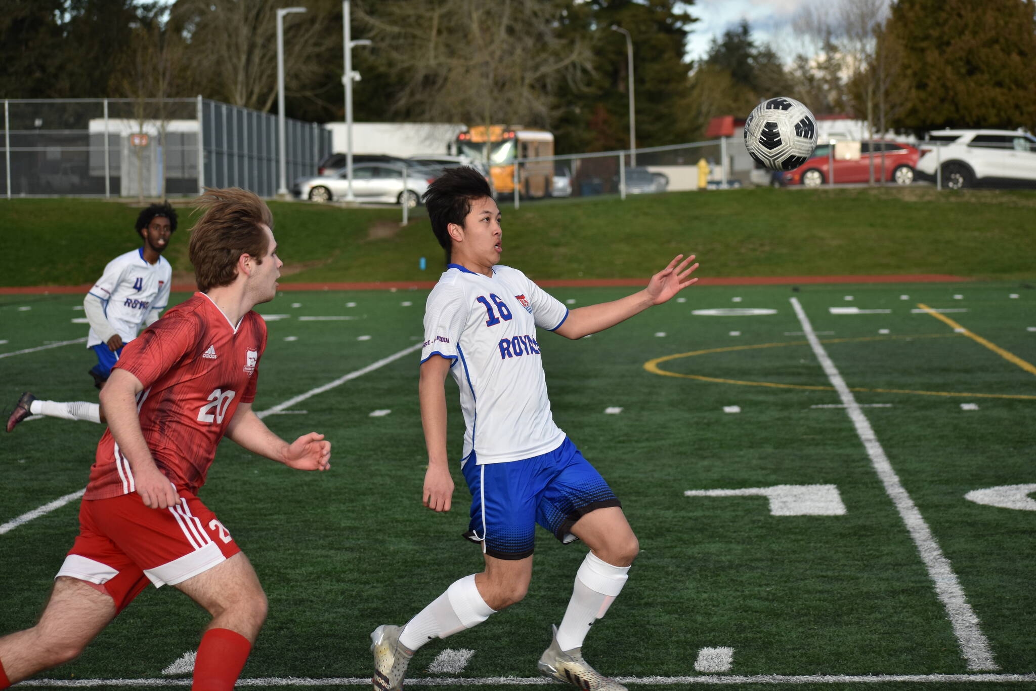 Royal junior Joshua Chansee eyes down the ball as a Raider closes in on him. Ben Ray / The Reporter