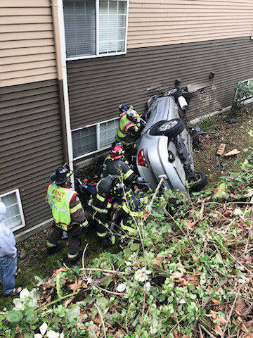 Puget Sound Fire responds to a car that went down an embankment and crashed into the Madison on the River Apartments Thursday morning, April 13. COURTESY PHOTO, Puget Sound Fire