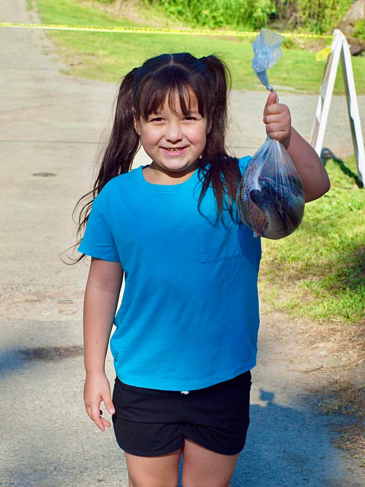 A girl shows off her catch during the Kent Parks Fishing Experience May 20 at the Old Fishing Hole. COURTESY PHOTO, Kent Parks