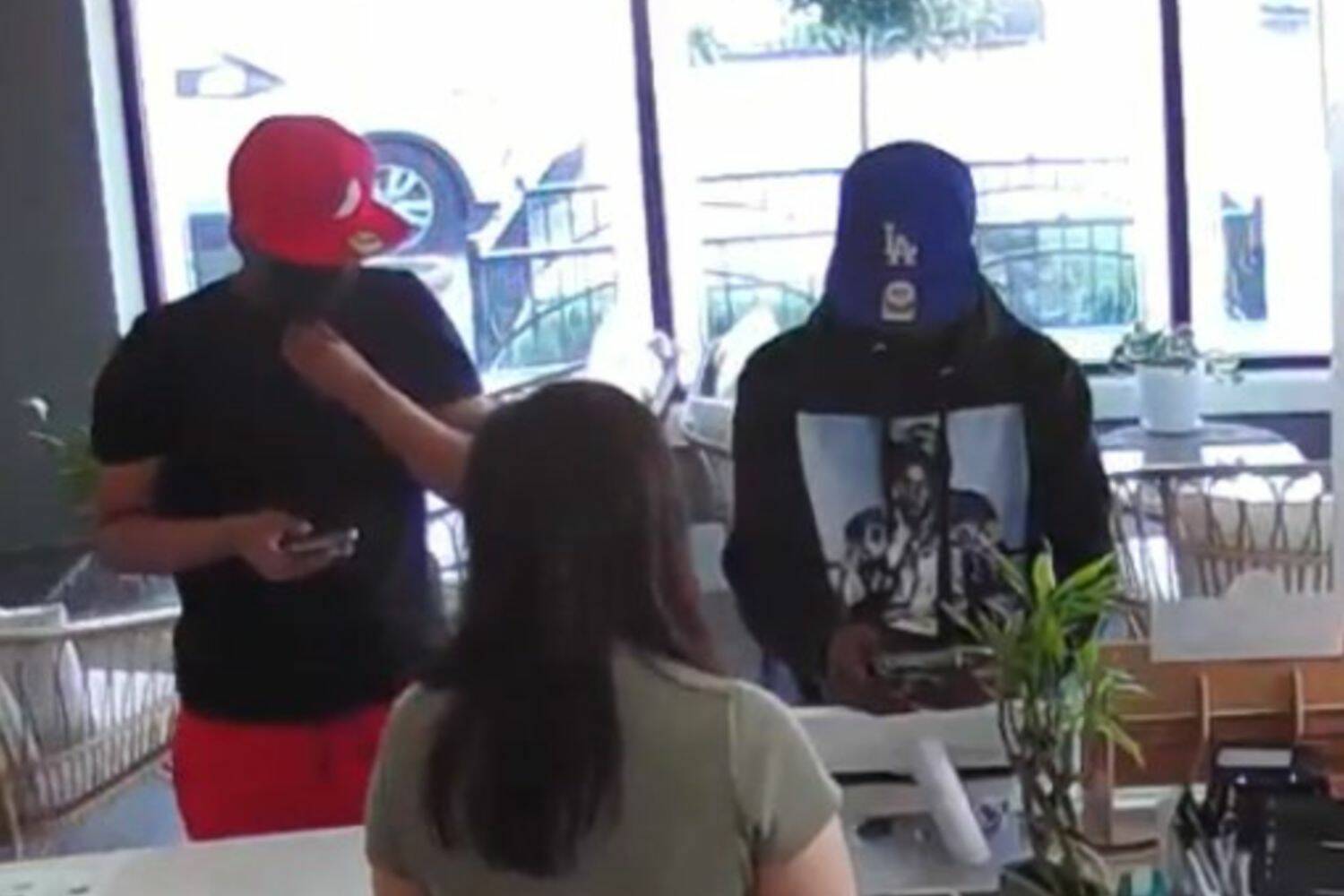 Scam suspects caught on security video in Downtown Renton. Screenshot from Renton Police Facebook post