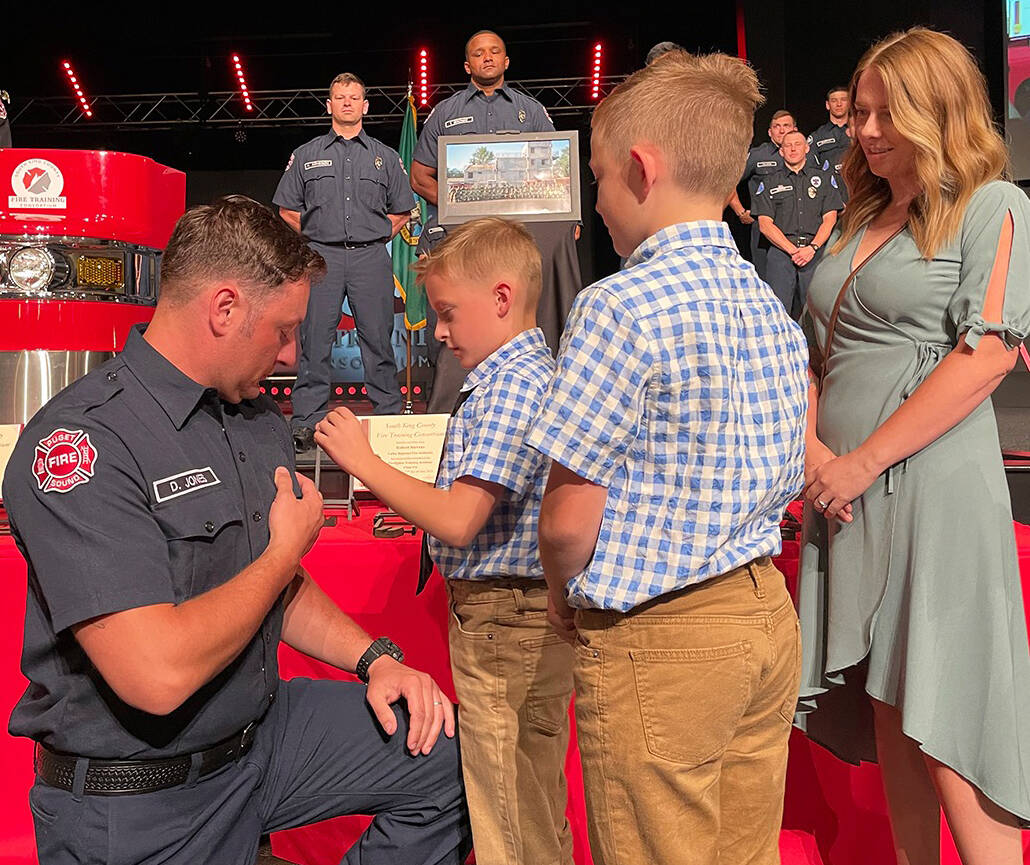 Puget Sound Fire firefighter Daniel Jones receives his badge during graduation June 27 from the South King County Fire Training Consortium. COURTESY PHOTO, Puget Sound Fire