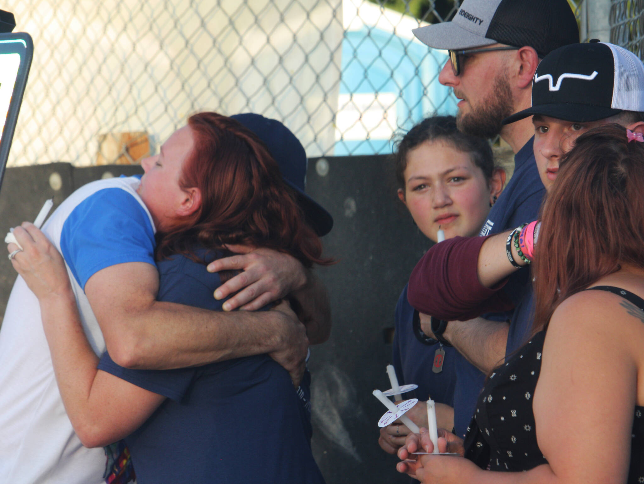 Shellie Coury, the mother of Gabriel, receives a hug as family members stand nearby. STEVE HUNTER, Kent Reporter