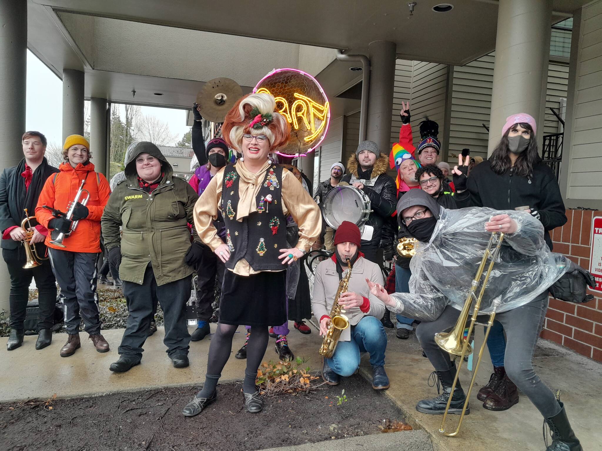 Photo by Bailey Jo Josie/Sound Publishing.
Sylvia O’Stayformore (center, in the Christmas sweater and wig) poses with counter-protesters hours before she reads children’s books for her monthly Drag Queen Story Time.