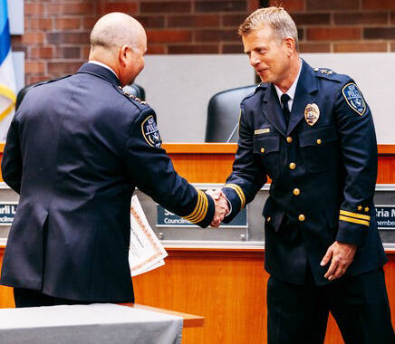 Kent Police Chief Rafael Padilla, left, congratulates Andy Grove on his promotion to assistant chief. COURTESY PHOTO, Kent Police