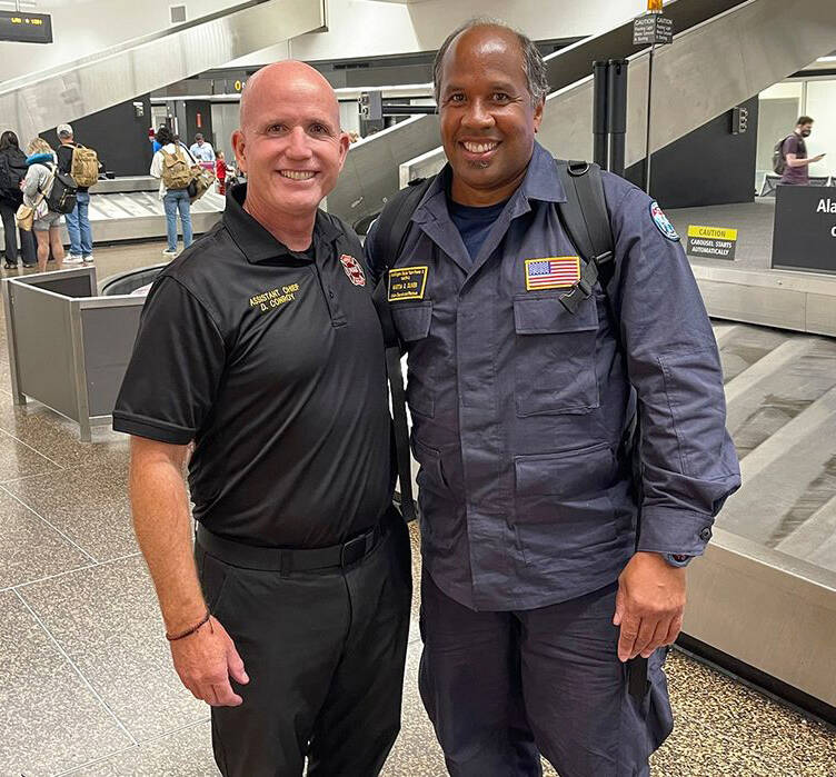 Kent-based Puget Sound Fire Assistant Chief Dan Conroy, left, welcomes home Capt. Martin Oliver Aug. 29 at Sea-Tac Airport after his work with Washington State Task Force 1 in Maui. COURTESY PHOTO, Puget Sound Fire