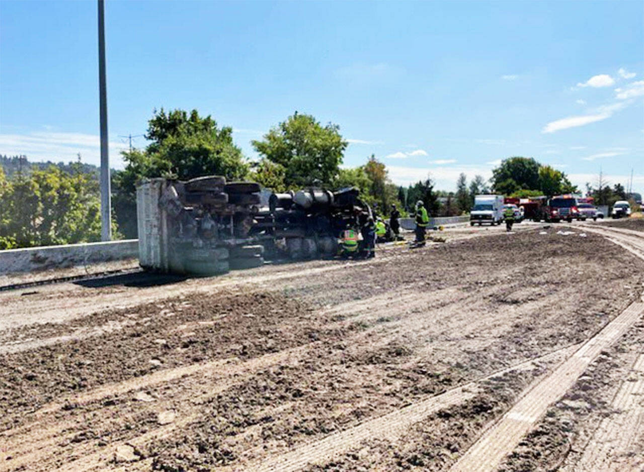 A dump truck driver died after his vehicle blew a tire, crashed and lost its load of mud on Wednesday, Sept. 7 on northbound State Route 167 near Willis Street (SR 516) in Kent. COURTESY PHOTO, Puget Sound Fire