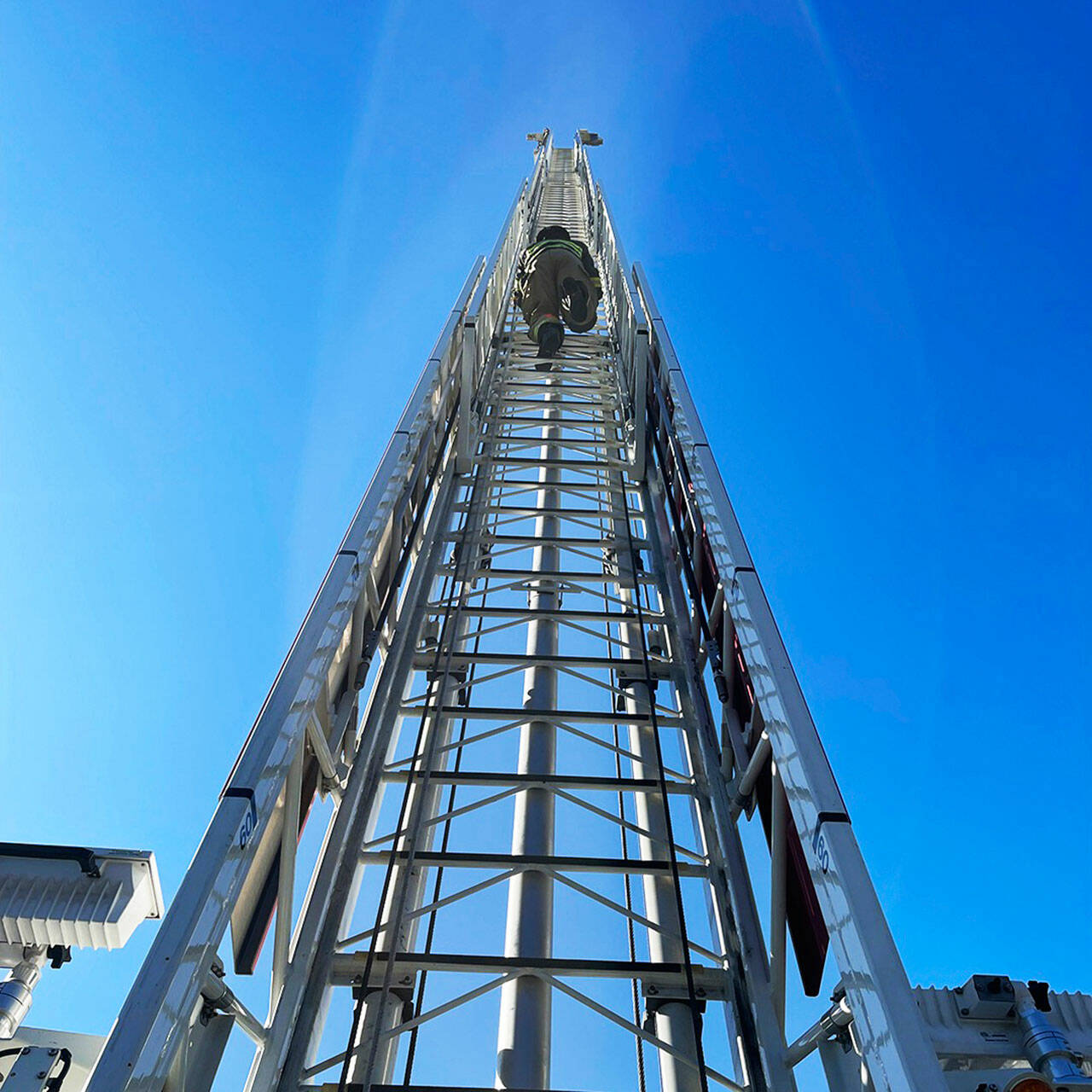 A firefighting recruit scoots up a 100-foot ladder at the South King County Fire Training Consortium in Kent. COURTESY PHOTO, Puget Sound Fire