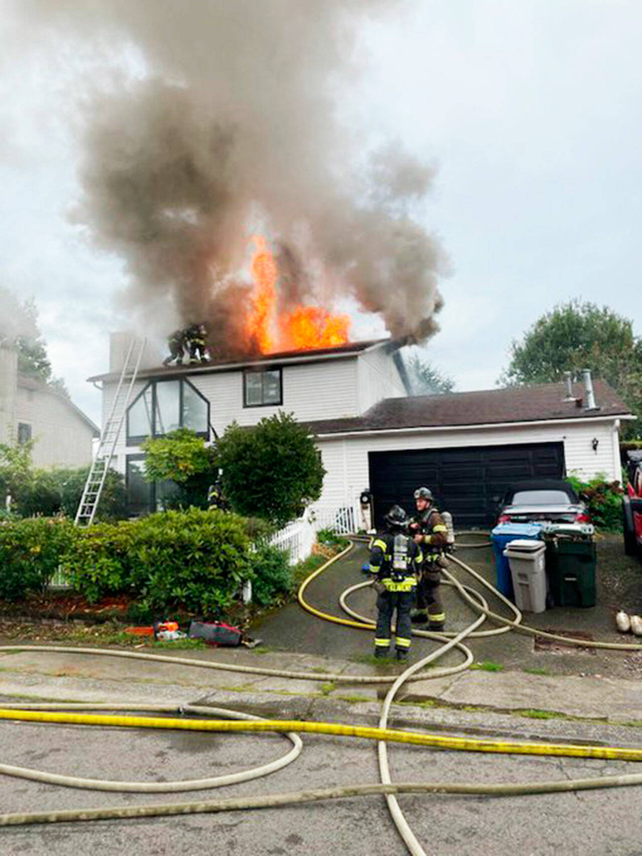 Firefighters battle a blaze at a Kent house Tuesday, Sept. 26 in the 13000 block of SE 215th Street. COURTESY PHOTO, Puget Sound Fire