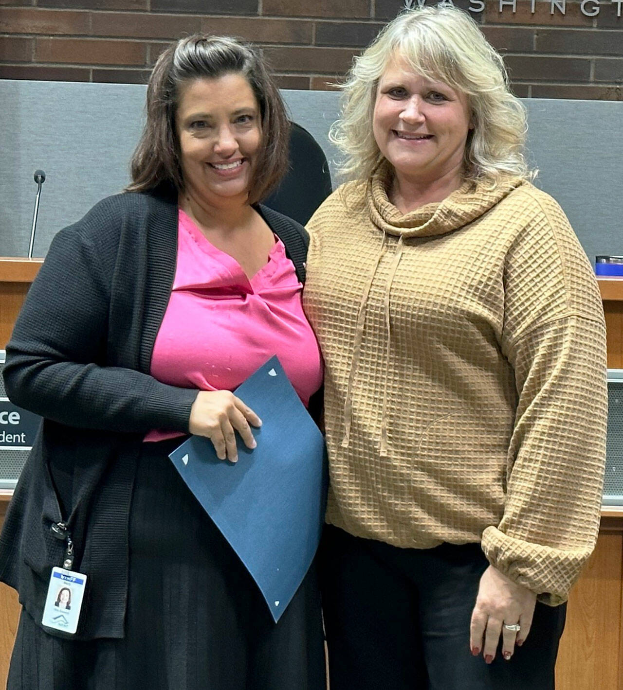 Kent City Councilmember Marli Larimer, left, receives a Breast Cancer Awareness Month proclamation from Mayor Dana Ralph at the Oct. 3 council meeting. Both women are breast cancer survivors. COURTESY PHOTO, City of Kent