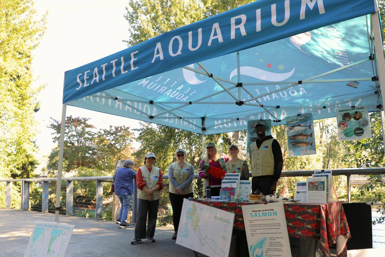 Volunteers from the Seattle Aquarium posted at the Renton Library to help teach people about the returning Cedar River salmon. (Cameron Sheppard/Sound Publishing)