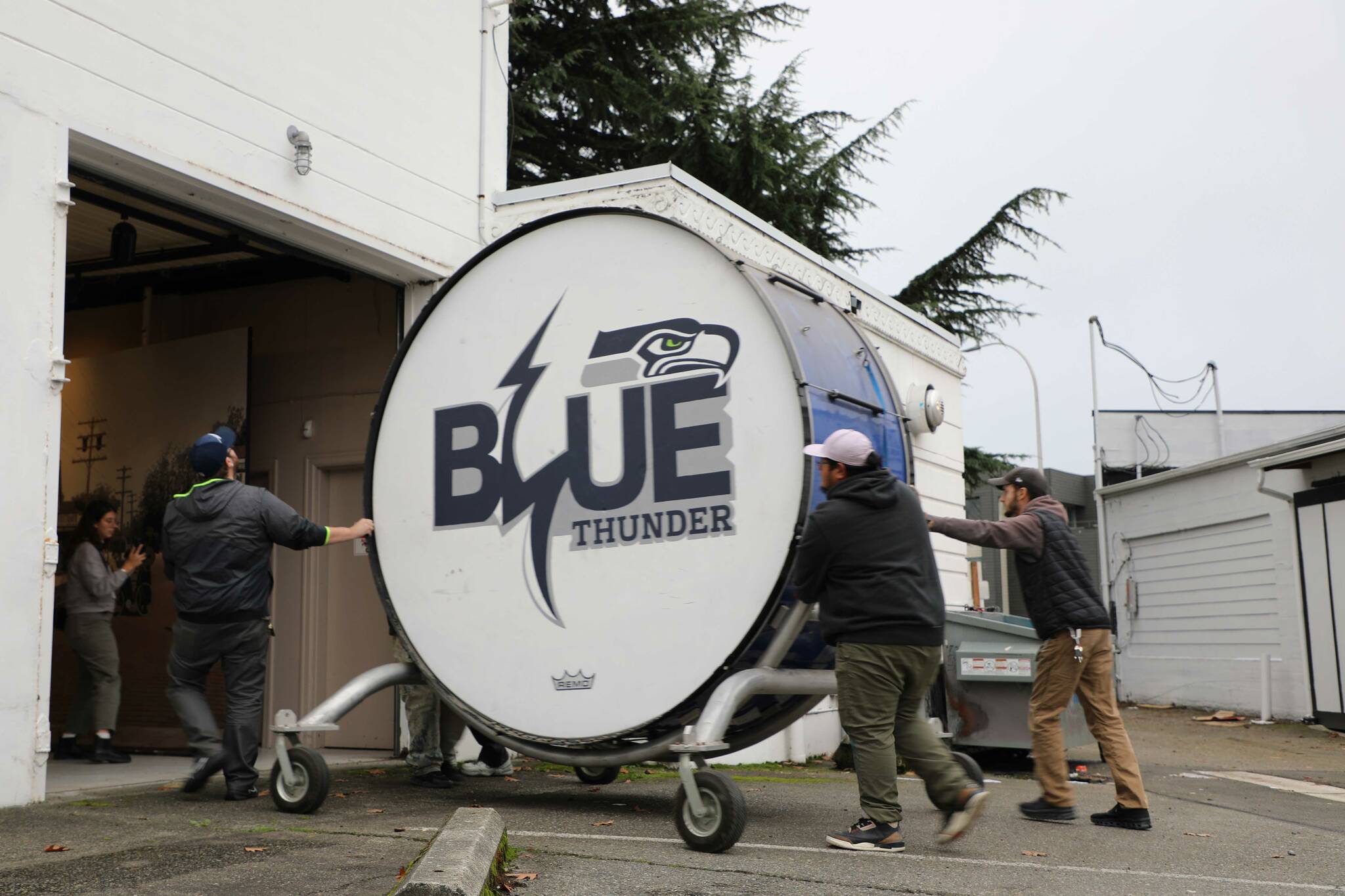 The bass drum is wheeled into the Renton History Museum. (Cameron Sheppard/Sound Publishing)