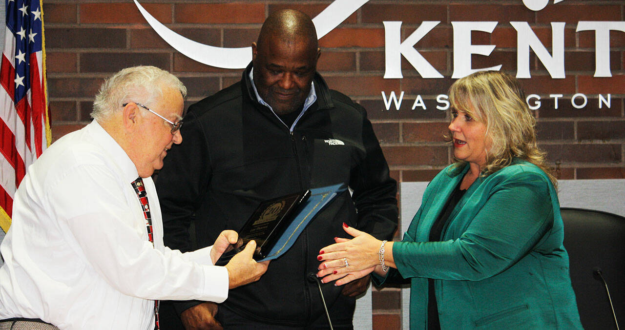 Les Thomas receives recognition for his 20 years on the council from Council President Bill Boyce, center, and Mayor Dana Ralph. STEVE HUNTER, Kent Reporter