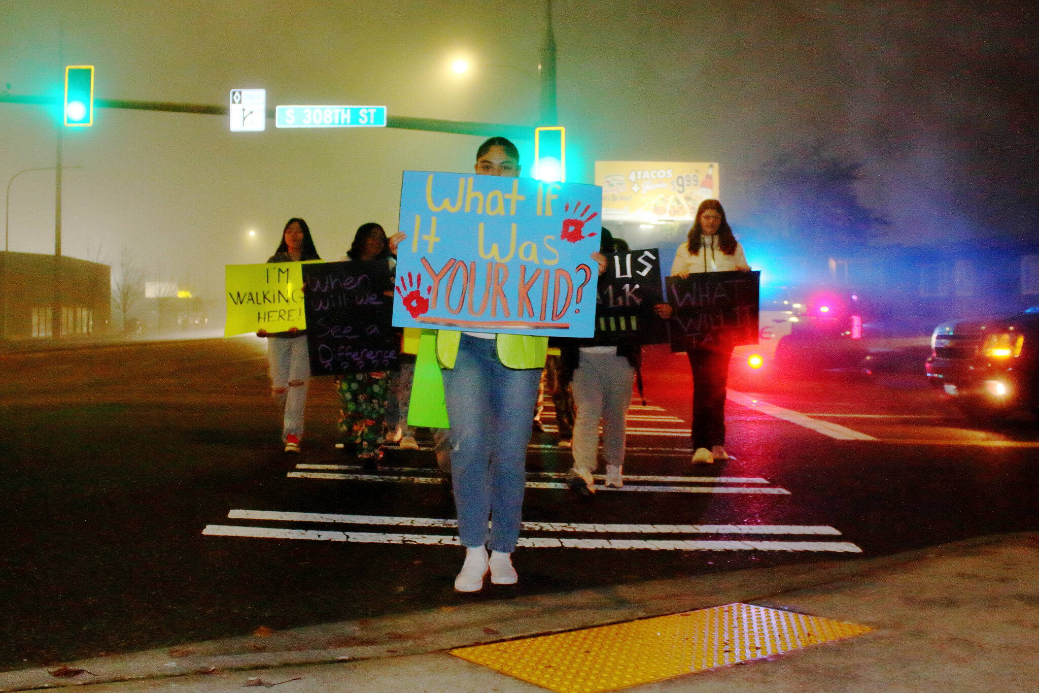 Student protesters crossed in the intersection between 308th Street and Pacific Highway where a student was recently hurt. (Photo by Keelin Everly-Lang / Sound Publishing)