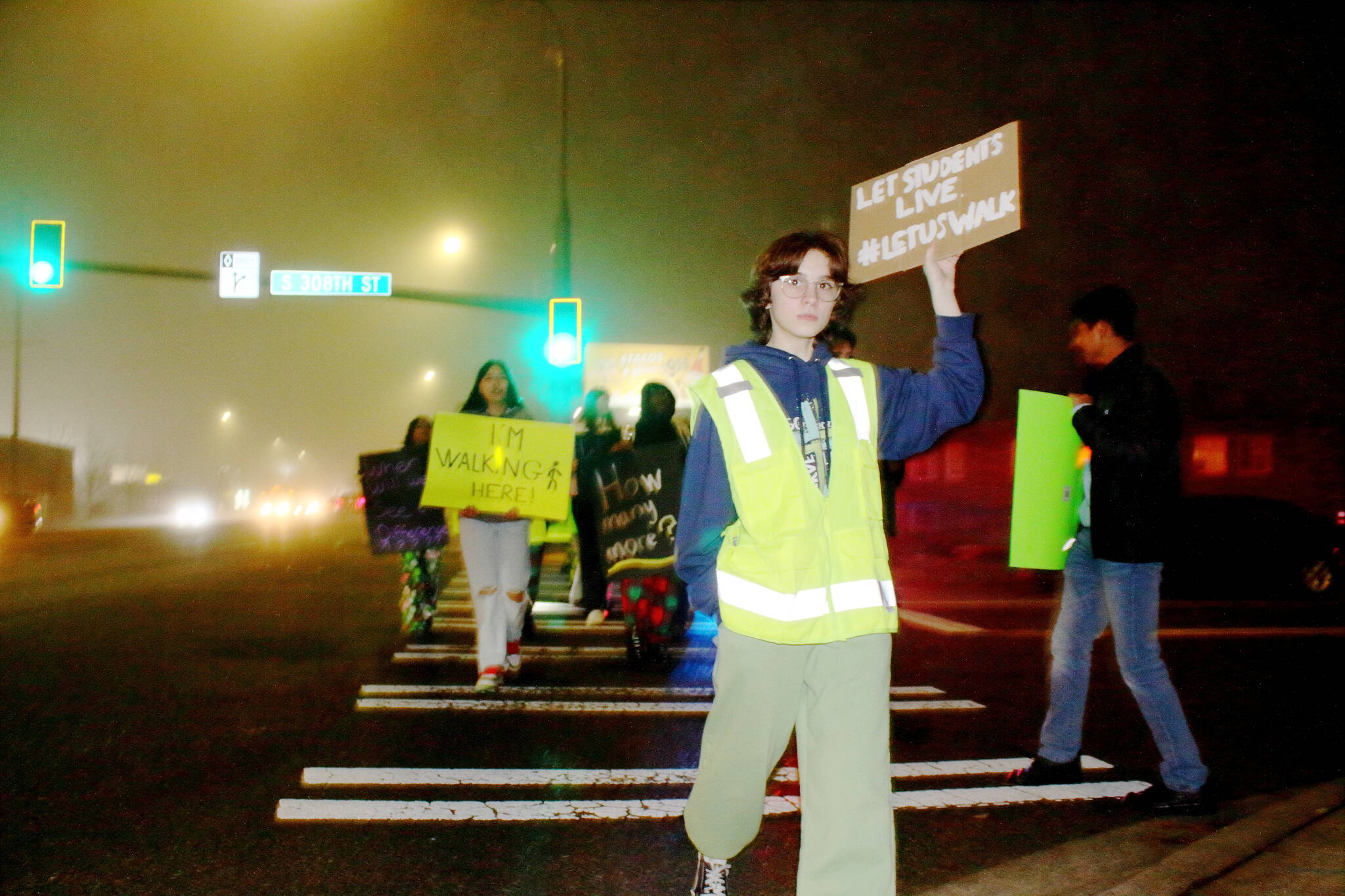 Students donned safety vests as they protested in the intersection in front of Federal Way High School that has been the site of multiple pedestrian incidents. (Photo by Keelin Everly-Lang / Sound Publishing)