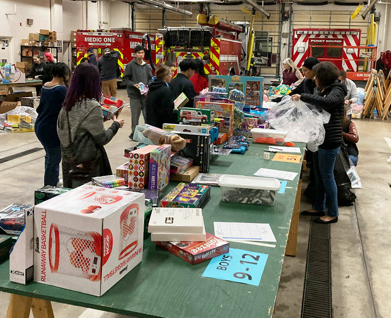 Volunteers sort items for the Toys for Joy program. COURTESY PHOTO, Puget Sound Fire