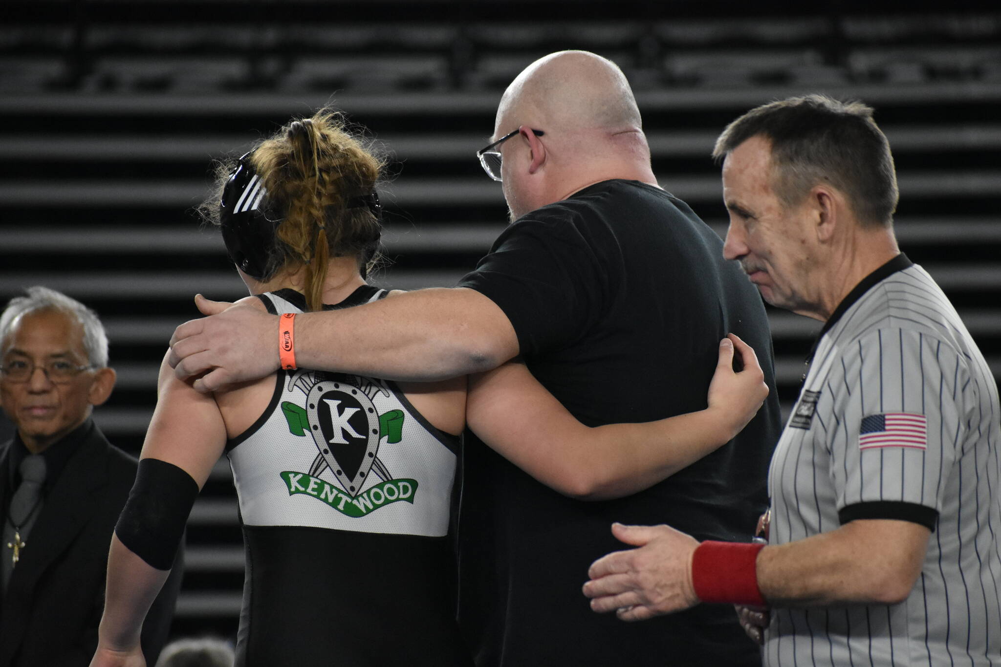 Sarah and Dan Wright walk off the mat together. Ben Ray / The Reporter