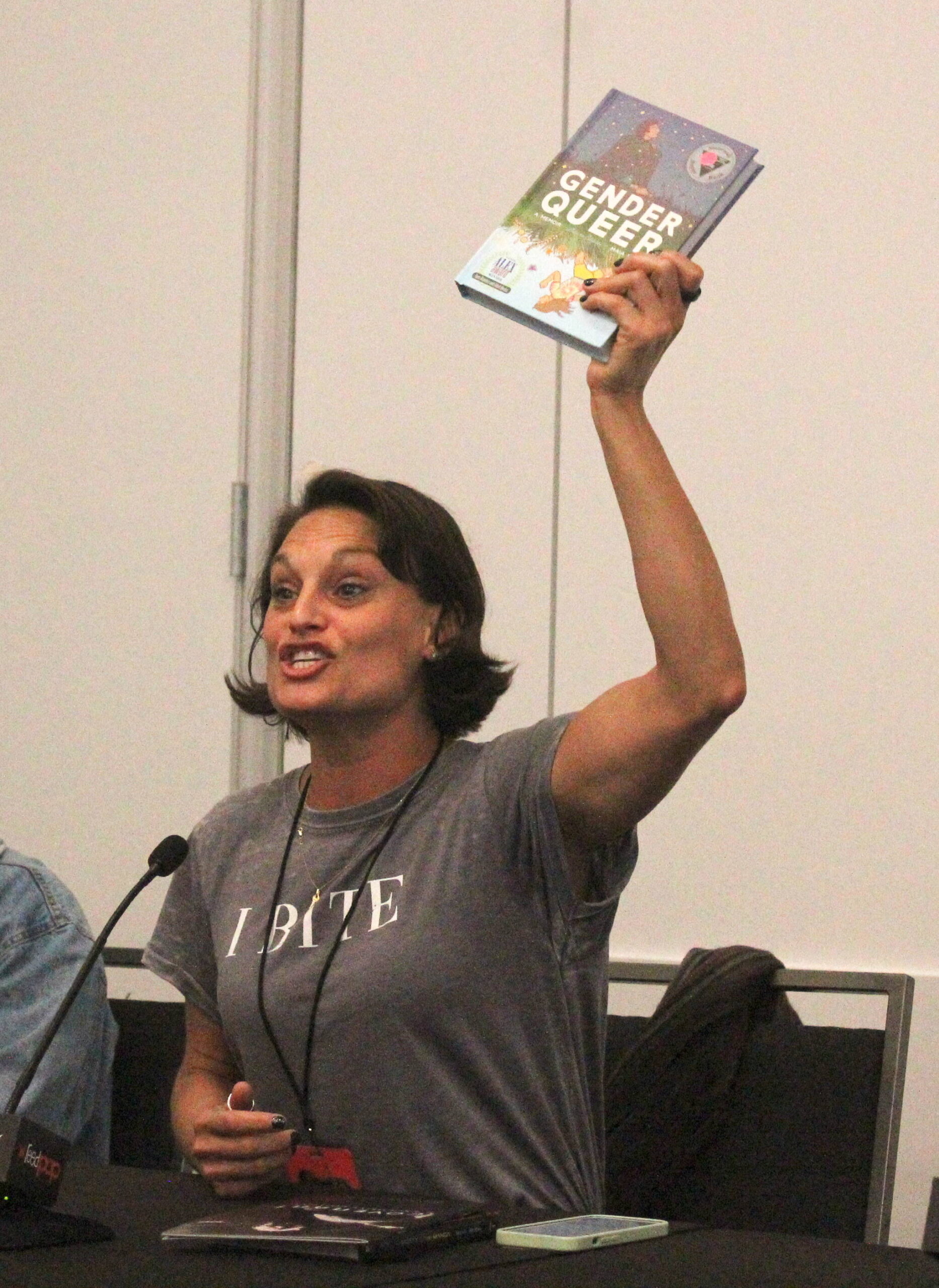 Writer Olivia Cuartero-Briggs holds up “Gender Queer: A Memoir” by Maia Kobabe, the most banned book in the United States, during an ECCC 2024 panel about banned books. Photo by Bailey Jo Josie/Sound Publishing