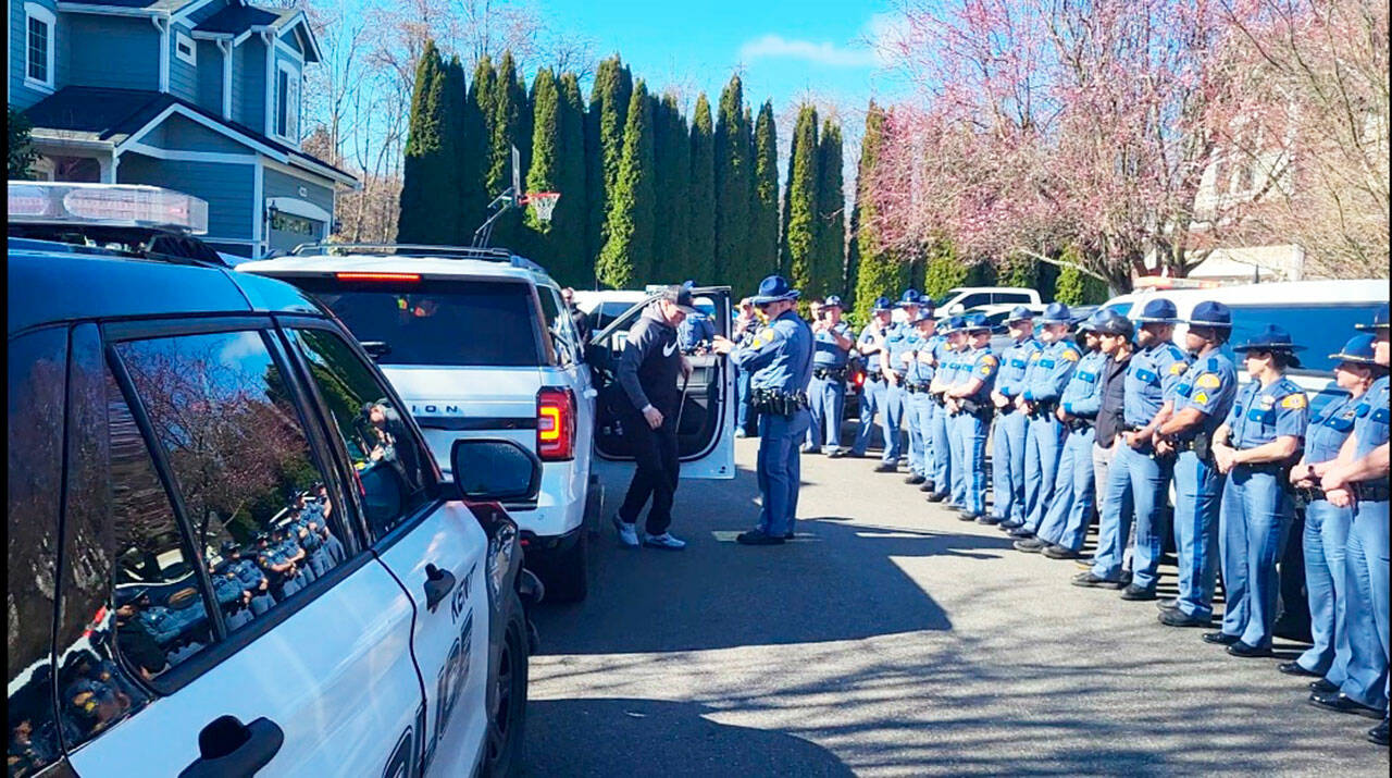Washington State Patrol Trooper Raymond Seaburg is welcomed home by fellow troopers after his release Tuesday, March 5 from Harborview Medical Center in Seattle. Seaburg had been in the hospital since Feb. 16 with gunshot wounds to the leg after he was shot in Kent. COURTESY PHOTO, Washington State Patrol