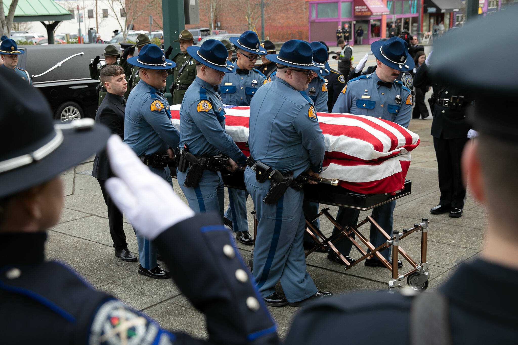 Washington State Trooper Chris Gadd is transported inside prior to a memorial service in his honor Tuesday, March 12, 2024, at Angel of the Winds Arena in Everett, Washington. (Ryan Berry / The Herald)