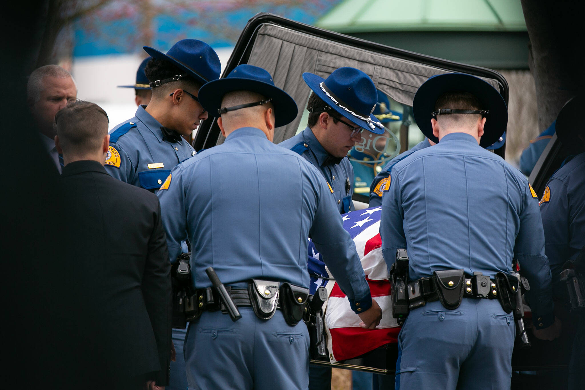 Fellow troopers carry the casket of Washington State Trooper Chris Gadd on Tuesday, March 12, 2024, during a memorial at Angel of the Winds Arena in Everett, Washington. (Ryan Berry / The Herald)