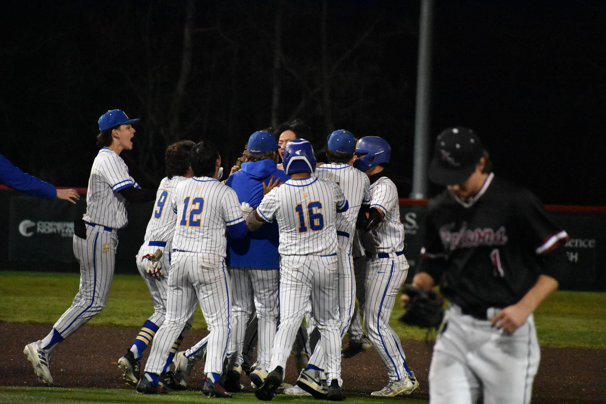 Hazen celebrates their walk-off win as Christopher Moore leaves the field. Ben Ray / The Reporter