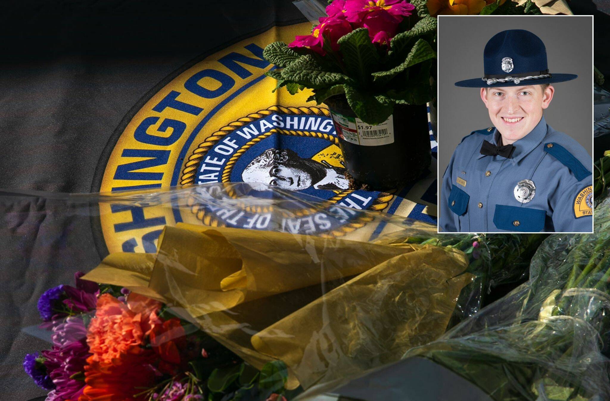 Flowers for slain trooper Chris Gadd begin to collect outside Washington State Patrol District 7 Headquarters on Saturday, March 2 in Marysville. (Ryan Berry / Sound Publishing)