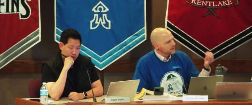 Kent School Board members Andy Song, left, and Donald Cook discuss a decision by the board to keep Cook out of meetings with labor groups to discuss contract negotiations. Screenshot, via Kent School District