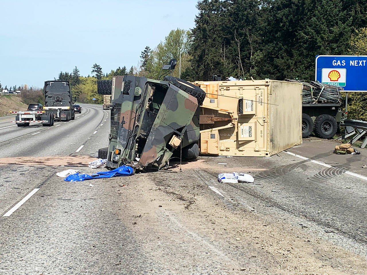 A military vehicle flipped on its side while traveling northbound Interstate 5 near South 272nd Street late Wednesday morning, April 10. COURTESY PHOTO, Washington State Patrol