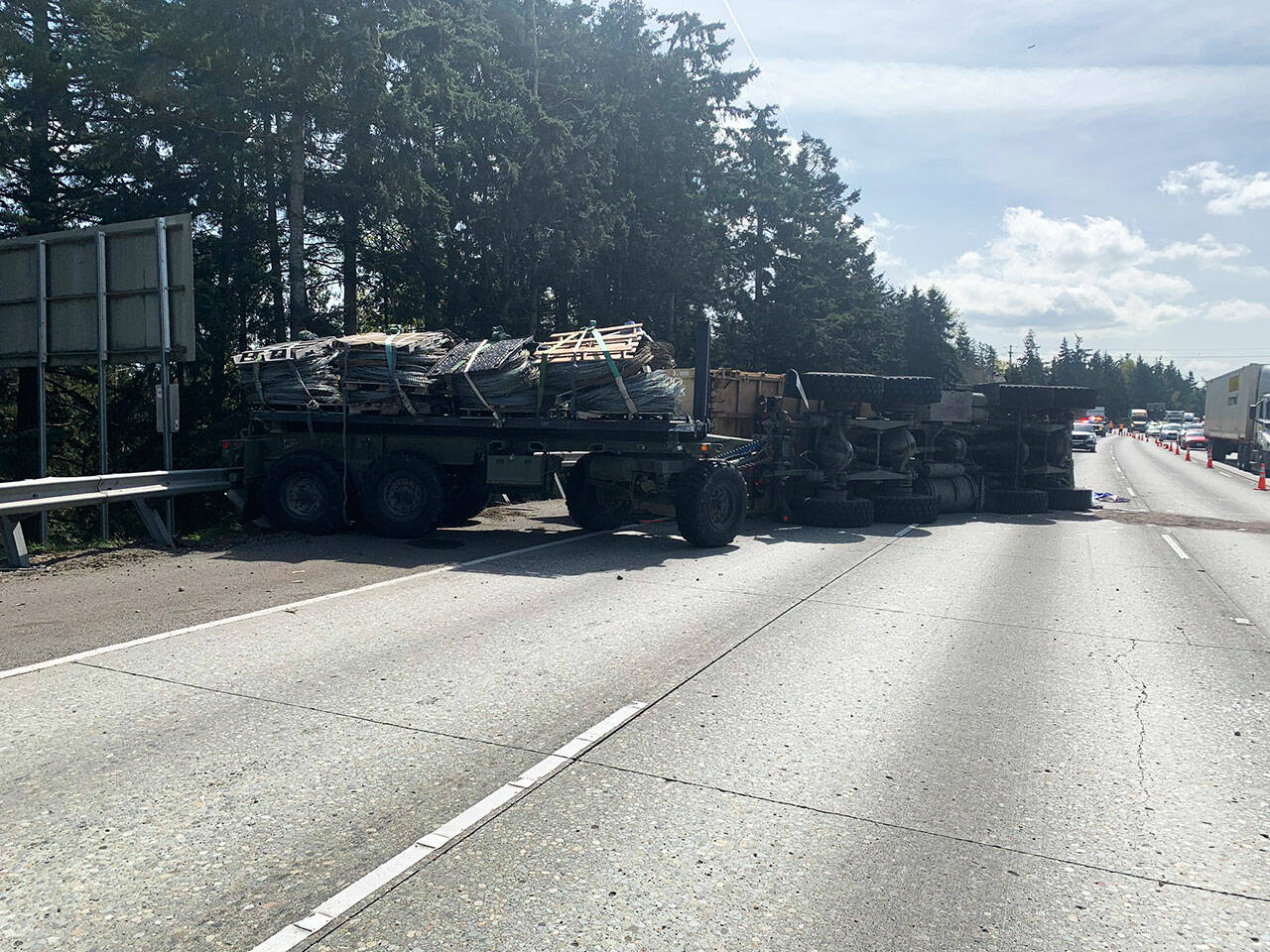 A military vehicle flipped on its side and blocked numerous northbound lanes of I-5 on Wednesday, April 10 near South 272nd Street. COURTESY PHOTO, Washington State Patrol