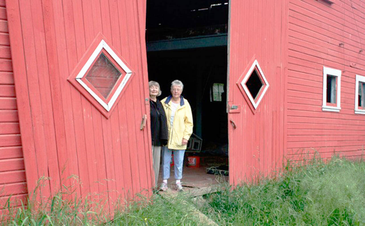 Sharon Bersaas and Nancy Simpson during a 2016 tour of the Dvorak Barn along the Green River in Kent that the women helped save. FILE PHOTO, Kent Reporter