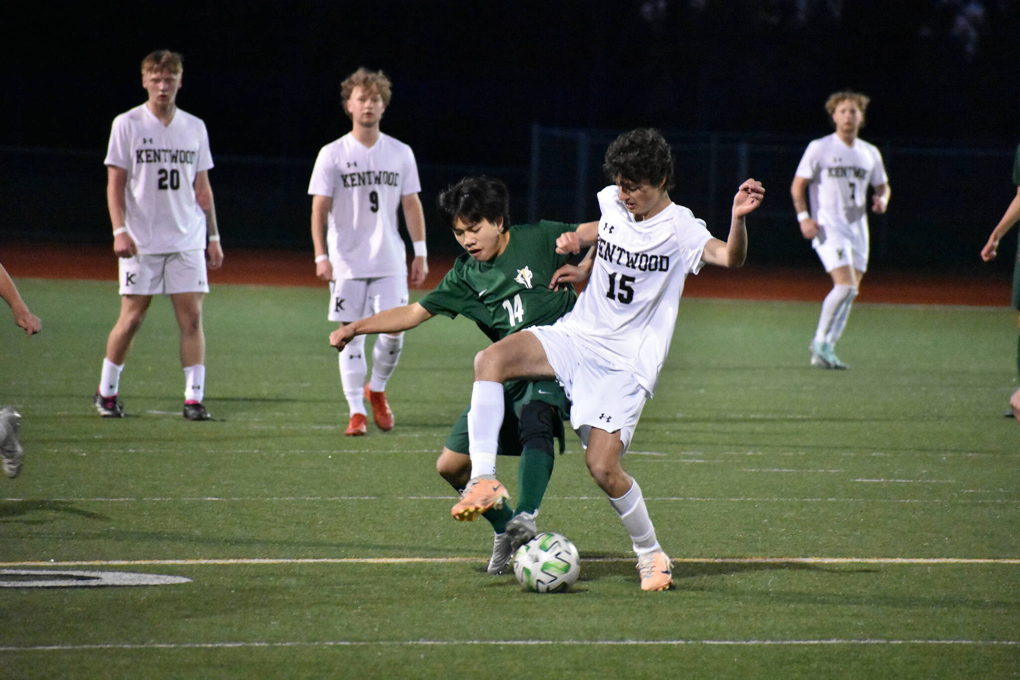 Ellis Nguyen and a Kentwood player fight to control the ball at Kentridge High School. Ben Ray / The Reporter