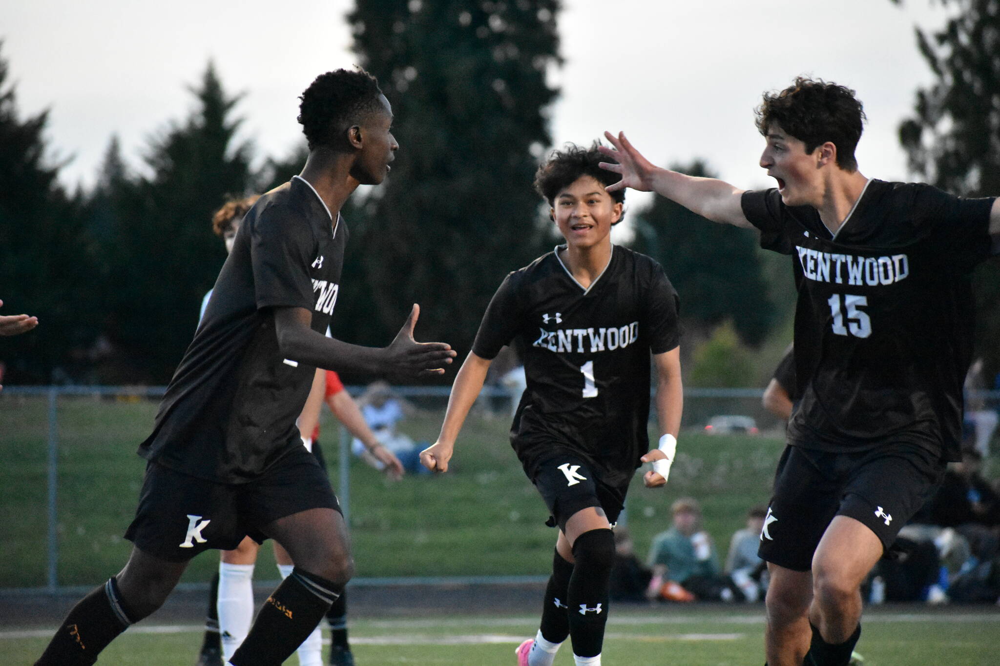 Manny Nzongani (left), Ethan Nonthaveth (middle) and Gabe Woodward (right) celebrate the first goal of the game. Ben Ray / The Reporter