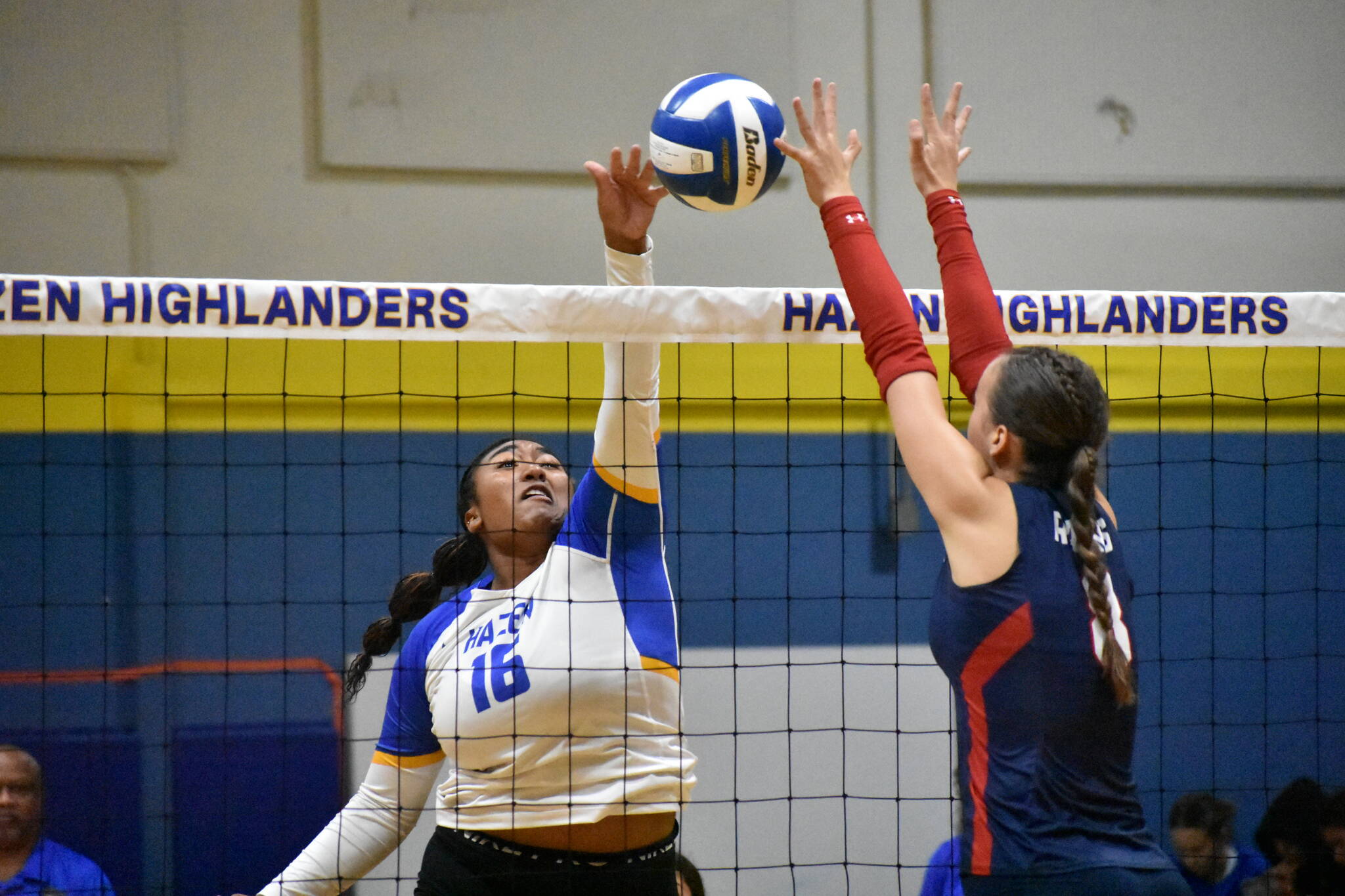 Senior Sienna German sends her left hand above the net to win a point for Hazen. Ben Ray / The Reporter