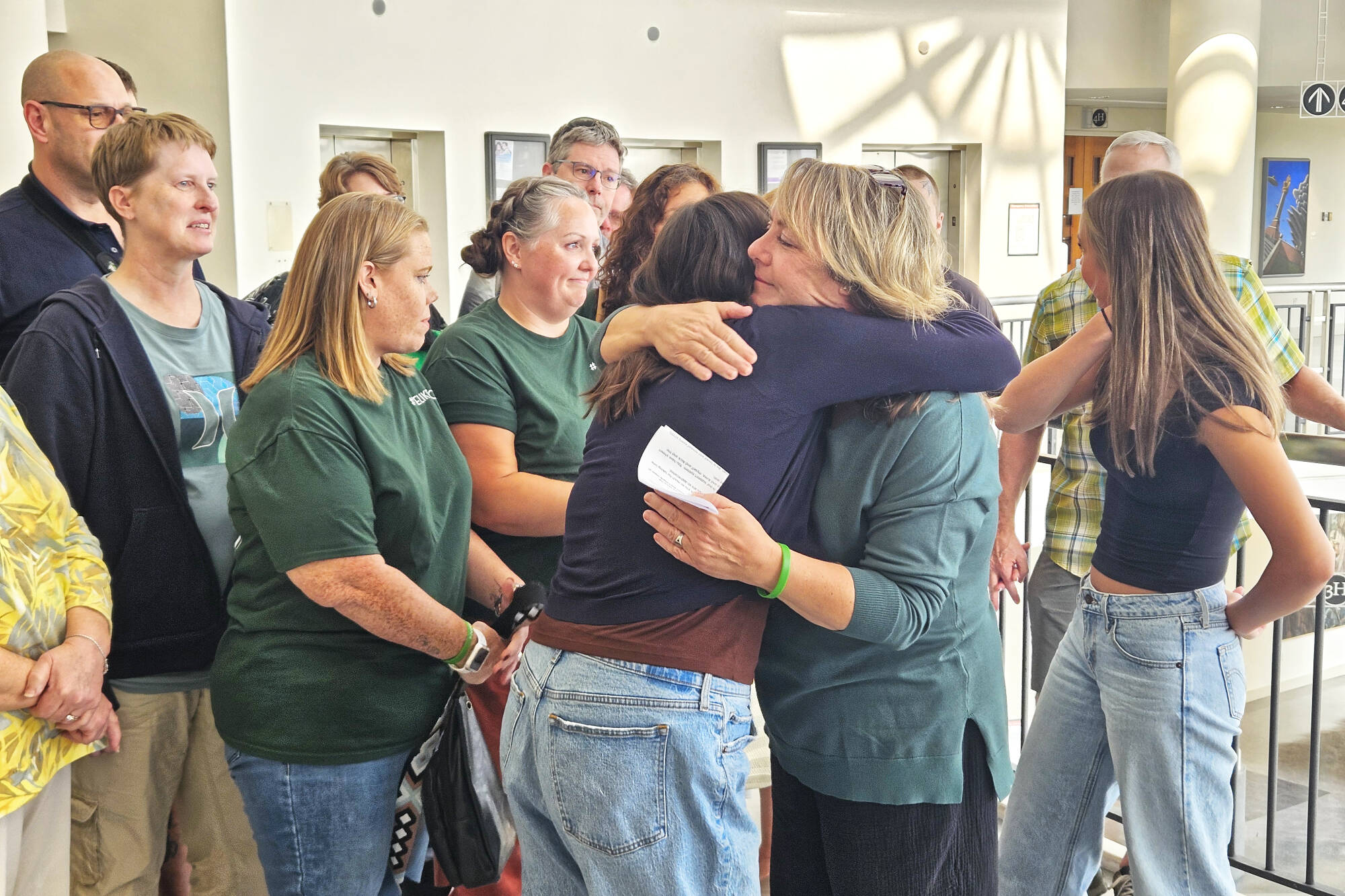 It was an emotional moment for Tanie Valison (pictured here hugging her daughter), her family, and her friends after the guilty verdict was read. Many of her group wore green, Nick Valison’s favorite color, throughout the trial. Photo by Ray Miller-Still