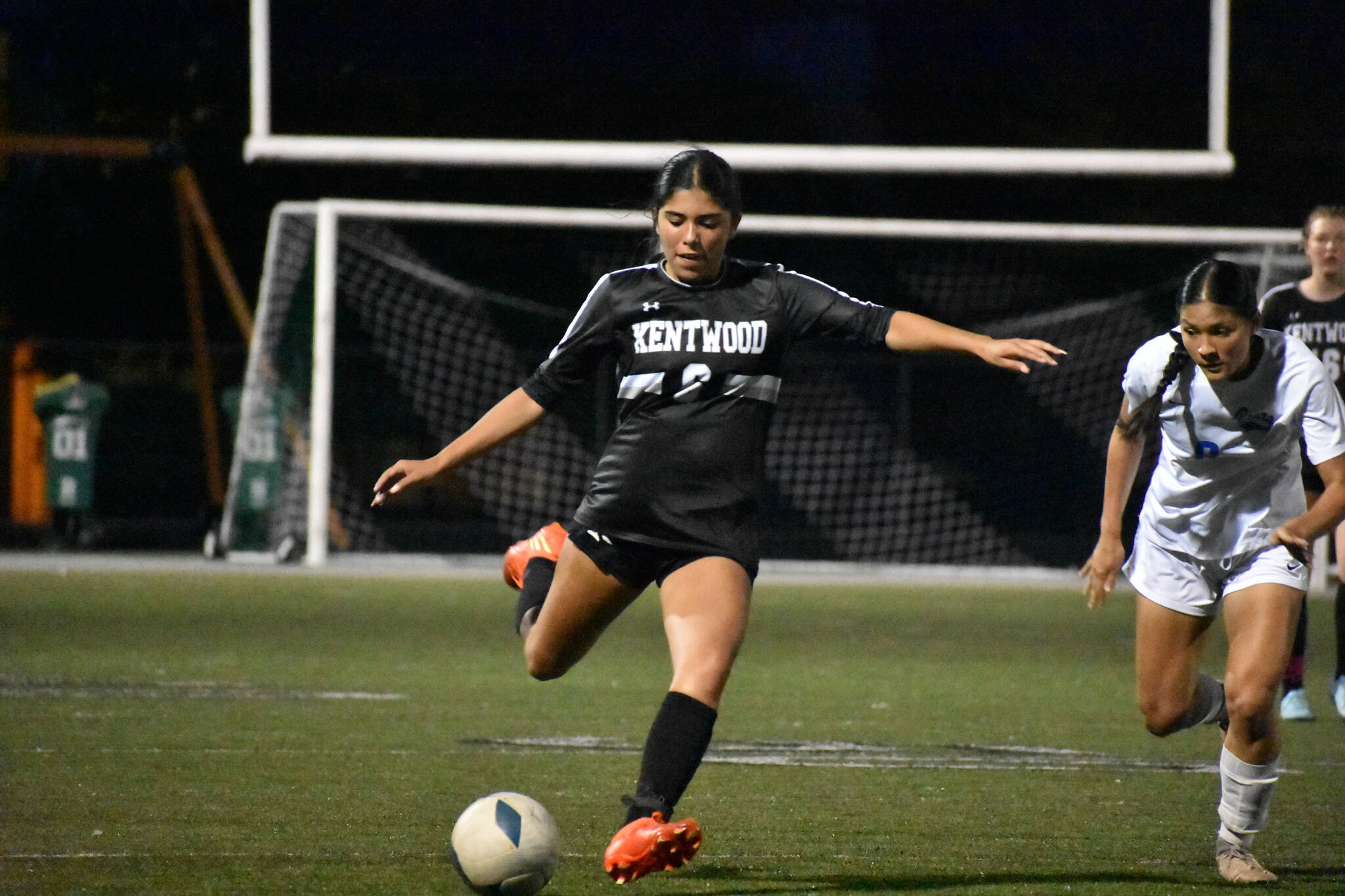 Reese Lee kicks the ball forward for Kentwood.