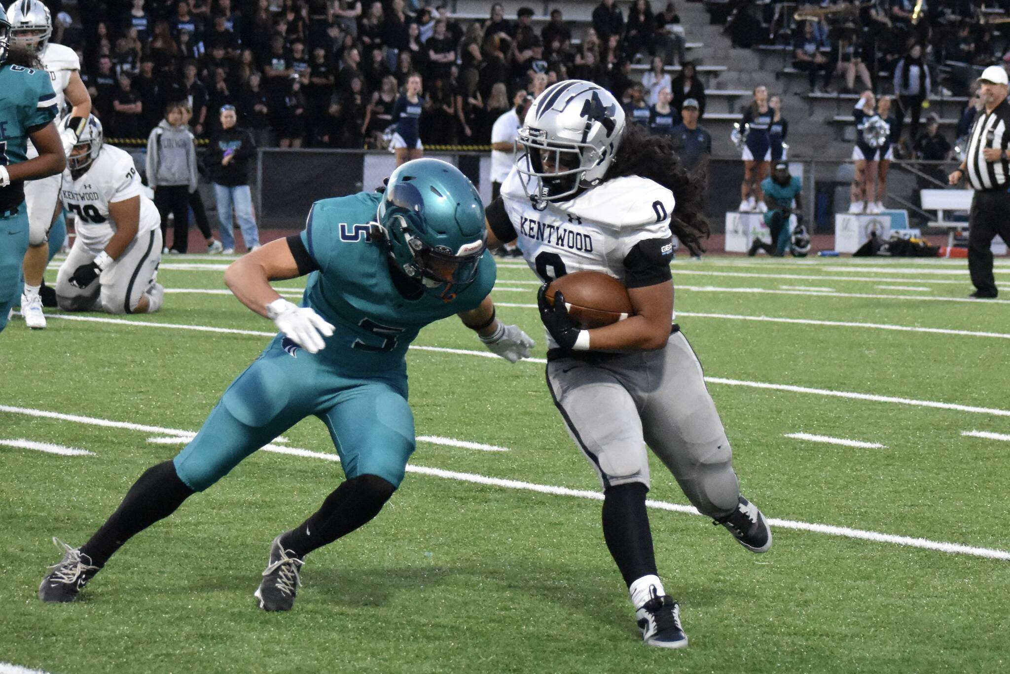 Kentwood running back Ezra Moaalii takes on an Auburn Riverside defender. Ben Ray / The Reporter